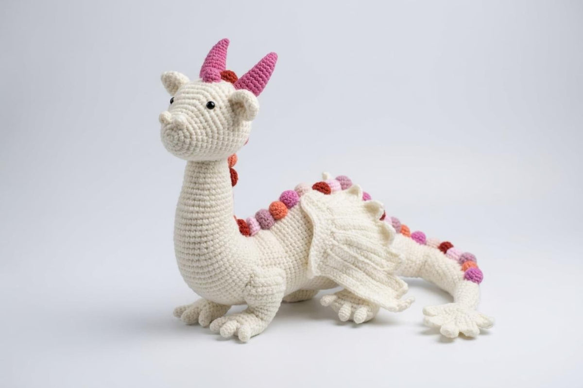 Crochet dragon amigurumi side view showing detailed wings and ombre spikes